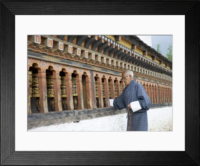 Framed Print : Old Bhutanese man turning prayer wheels in Buddhist temple, Thimphu, Bhutan, Asia
