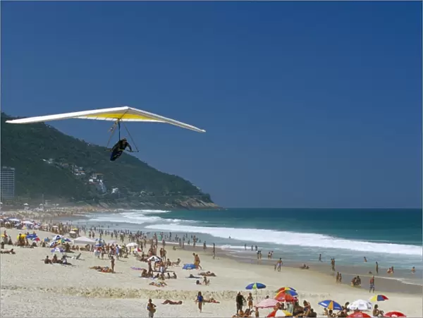 Hang-glider landing on Pepino beach, Rio de Janeiro, Brazil, South America