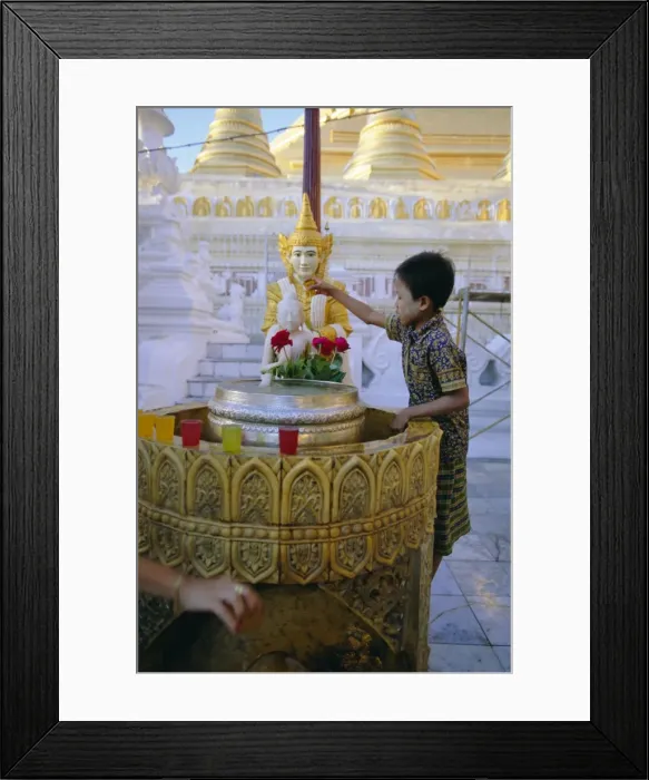 Framed Print : A boy places offerings to the Buddha, Shwedagon Paya (Shwe Dagon pagoda) Framed Print : A boy places offerings to the Buddha, Shwedagon Paya (Shwe Dagon pagoda)