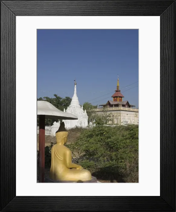 Framed Print : Buddha image sitting under parasol near pagodas, Salay, Myanmar (Burma), Asia Framed Print : Buddha image sitting under parasol near pagodas, Salay, Myanmar (Burma), Asia