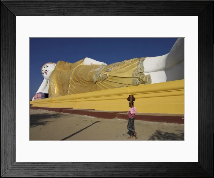 Framed Print : Woman walking past one of the largest reclining Buddha statues in the world Framed Print : Woman walking past one of the largest reclining Buddha statues in the world