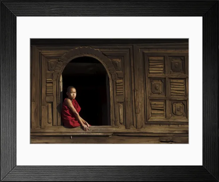 Framed Print : Novice monk sitting in window of 18th century wooden monastery of Nat Taung Kyaung Framed Print : Novice monk sitting in window of 18th century wooden monastery of Nat Taung Kyaung