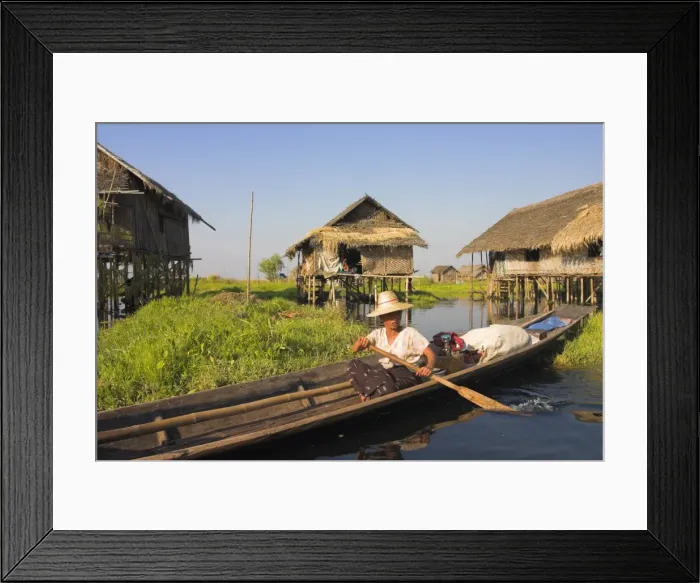 Framed Print : Woman in canoe paddles past floating village, Inle Lake, Shan State, Myanmar (Burma) Framed Print : Woman in canoe paddles past floating village, Inle Lake, Shan State, Myanmar (Burma)