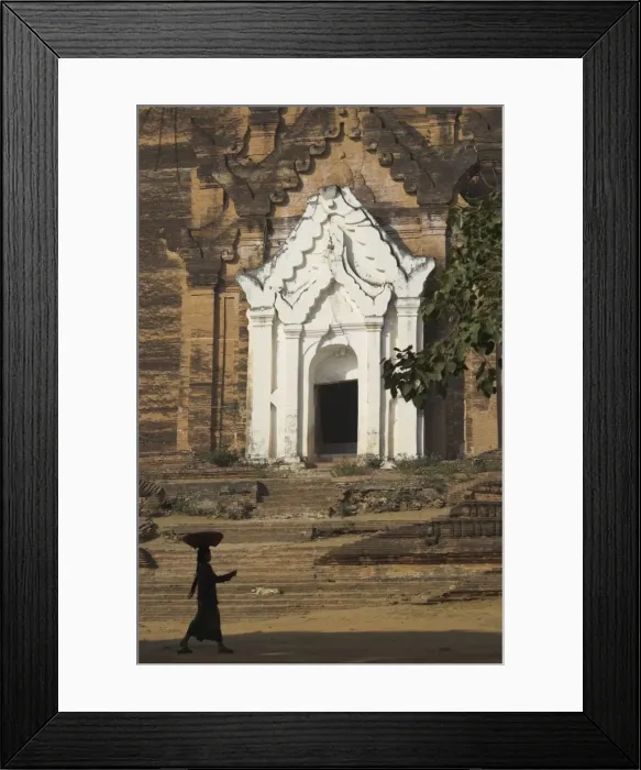 Framed Print : Silhouette of a woman with tray on her head walking past stupa entrance Framed Print : Silhouette of a woman with tray on her head walking past stupa entrance
