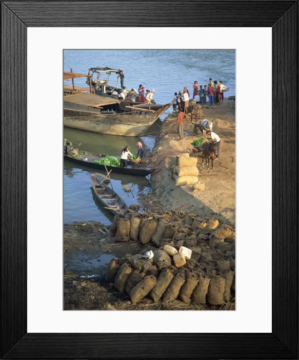 Framed Print : Bags of coal on the shore and boats in the background at Stung Treng, Cambodia Framed Print : Bags of coal on the shore and boats in the background at Stung Treng, Cambodia