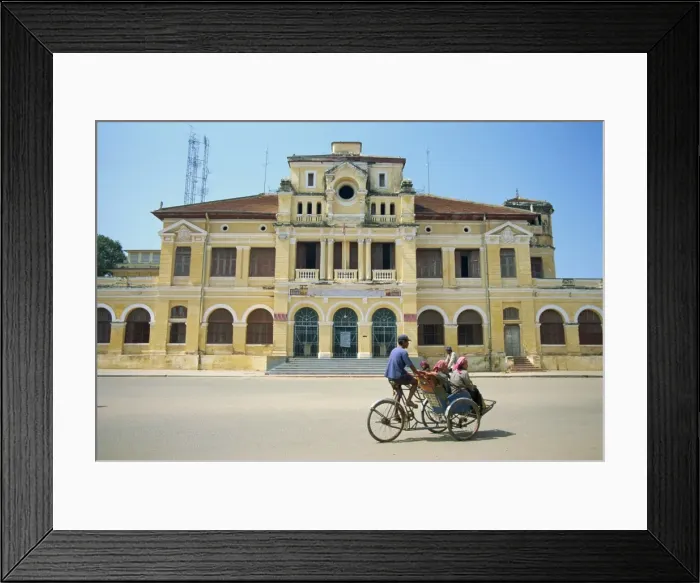 Framed Print : A cyclo passing the Old Post Office in Phnom Penh in Cambodia, Indochina Framed Print : A cyclo passing the Old Post Office in Phnom Penh in Cambodia, Indochina