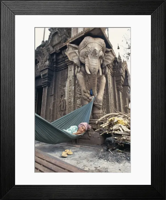 Framed Print : Homeless woman in a hammock attached to an elephant carving in a central temple in Phnom Penh Framed Print : Homeless woman in a hammock attached to an elephant carving in a central temple in Phnom Penh