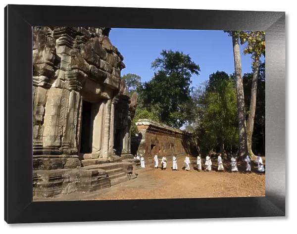 A procession of Buddhist nuns file through the temples of Angkor, UNESCO World Heritage Site