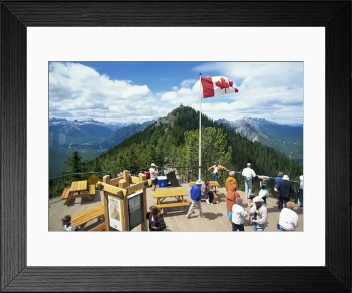 Framed Print : Tourists beneath the Canadian flag on Sulphur Mountain in the Banff National Park in Alberta Framed Print : Tourists beneath the Canadian flag on Sulphur Mountain in the Banff National Park in Alberta