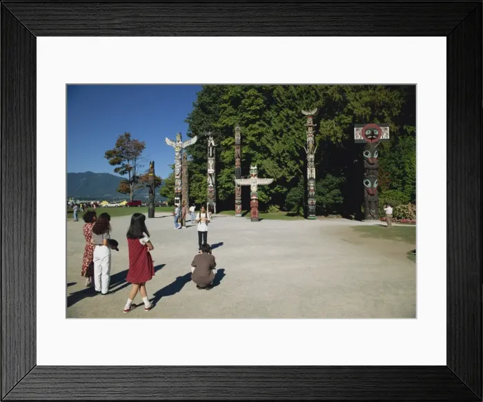 Framed Print : Tourists visiting Totems at Stanley Park in Vancouver, British Columbia Framed Print : Tourists visiting Totems at Stanley Park in Vancouver, British Columbia