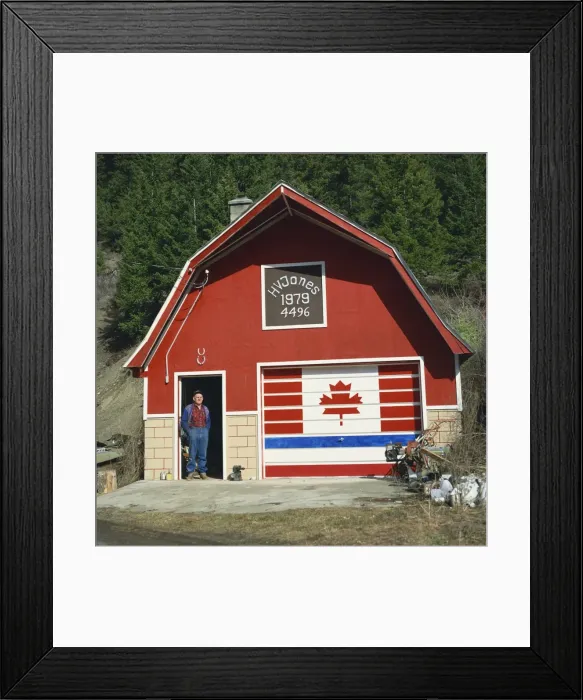 Framed Print : A man stands in the doorway beneath two lucky horseshoes, beside a door painted with the Canadian flag, at a patriotic workshop near Vernon, British Columbia, Canada Framed Print : A man stands in the doorway beneath two lucky horseshoes, beside a door painted with the Canadian flag, at a patriotic workshop near Vernon, British Columbia, Canada