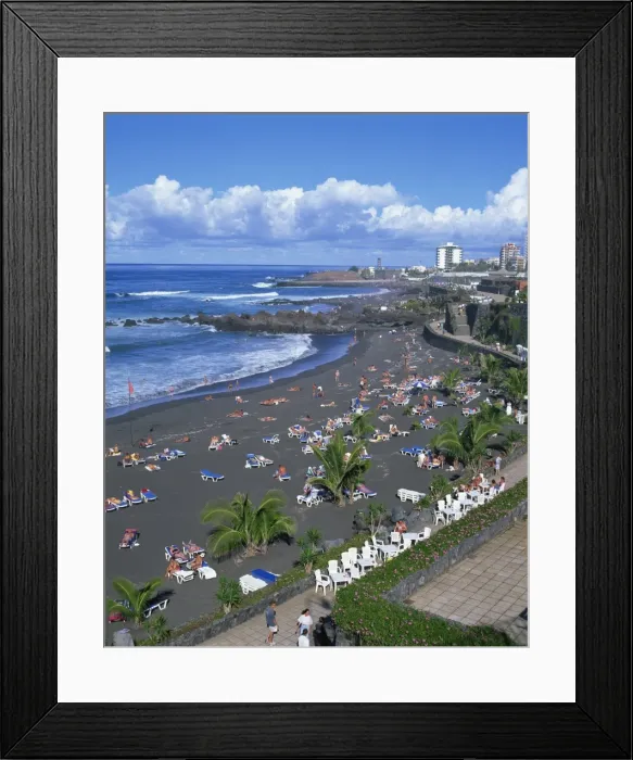 Framed Print : Tourists on volcanic sand beach at Playa Jardin, with San Felipe Castle Framed Print : Tourists on volcanic sand beach at Playa Jardin, with San Felipe Castle