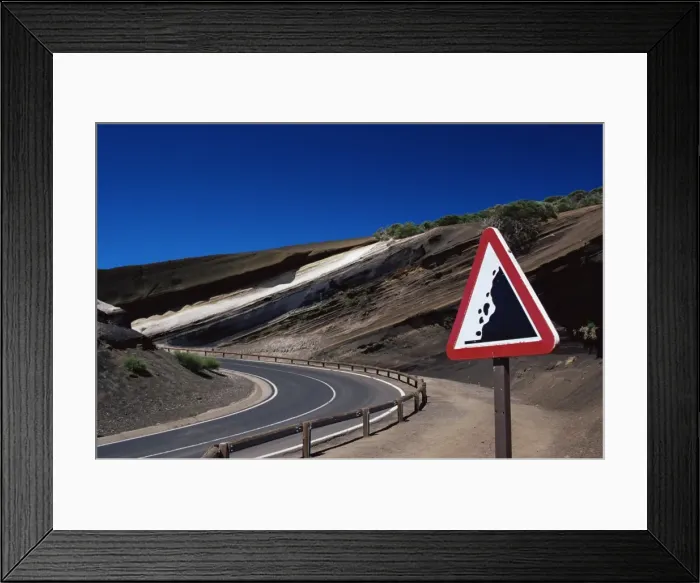 Framed Print : Sign on road with stratified volcanic rocks in the background, Parque Nacional del Teide Framed Print : Sign on road with stratified volcanic rocks in the background, Parque Nacional del Teide