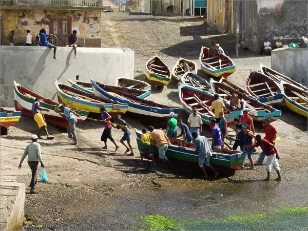 Fishermen taking boat out of water at the port of Ponto do Sol, Ribiera Grande