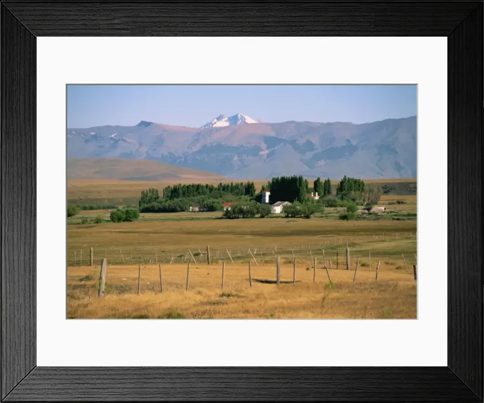 Framed Print : Ranch at Villa Castillo, farmland and mountains behind, in Patagonia, Chile Framed Print : Ranch at Villa Castillo, farmland and mountains behind, in Patagonia, Chile