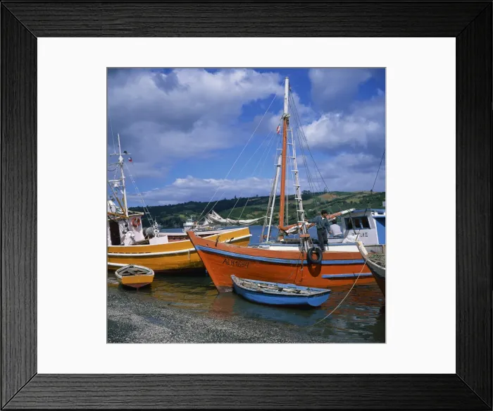 Framed Print : Fishermen on fishing boats moored on the beach at Dalcahue village on Chiloe Island Framed Print : Fishermen on fishing boats moored on the beach at Dalcahue village on Chiloe Island