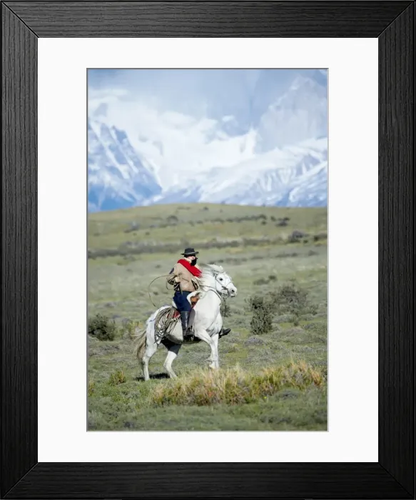 Framed Print : A gaucho riding his horse with Cuernos del Paine (Horns of Paine) mountains in the background Framed Print : A gaucho riding his horse with Cuernos del Paine (Horns of Paine) mountains in the background