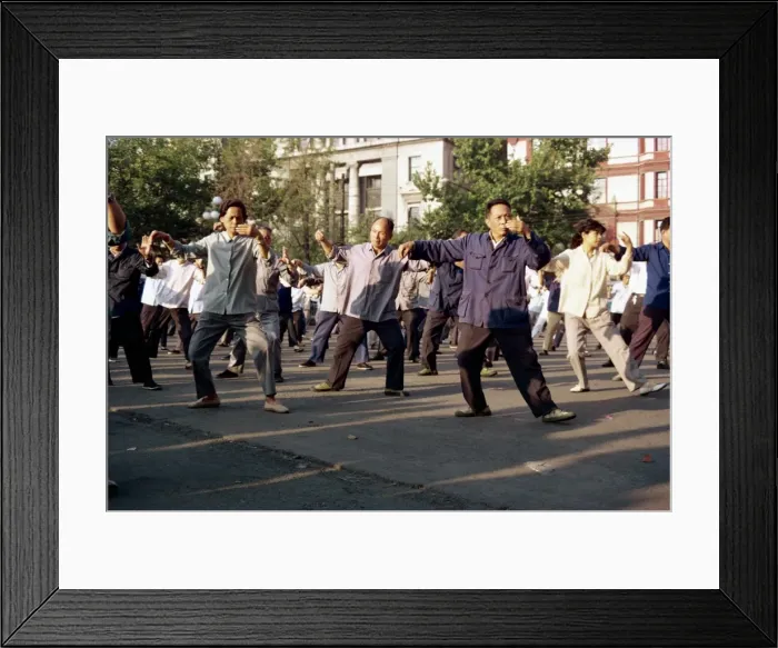 Framed Print : A group of men and women doing tai-chi exercises in the open air on the Bund in Shanghai Framed Print : A group of men and women doing tai-chi exercises in the open air on the Bund in Shanghai