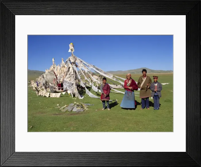 Framed Print : A family standing beside prayer flags at Huashixia in Qinghai, China, Asia Framed Print : A family standing beside prayer flags at Huashixia in Qinghai, China, Asia
