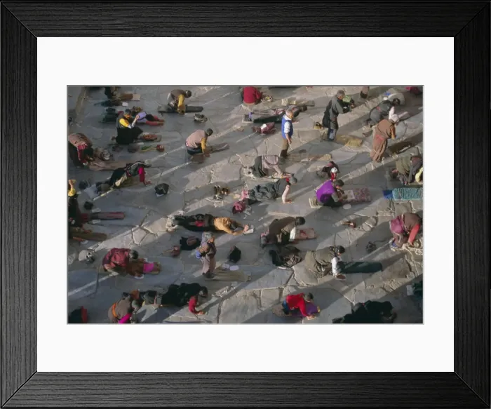 Framed Print : Tibetan Buddhist pilgrims prostrating outside the Jokhang Temple, Lhasa Framed Print : Tibetan Buddhist pilgrims prostrating outside the Jokhang Temple, Lhasa