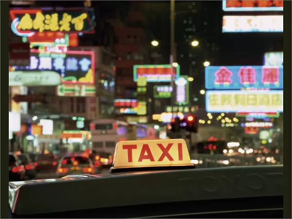 Taxi sign and neon lights at night on Nathan Road, Kowloon, Hong Kong, China, Asia