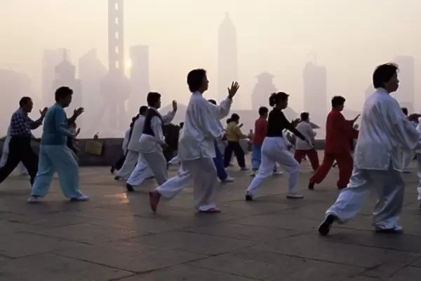 People doing early morning t ai chi exercises in the Huangpu Park on the Bund