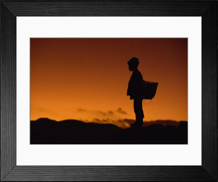 Framed Print : Young boy silhouetted against sky at dusk, Tibet, China, Asia Framed Print : Young boy silhouetted against sky at dusk, Tibet, China, Asia