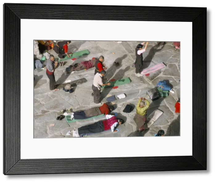 Framed Print : Pilgrims prostrating in front square, Jokhang Buddhist temple, Lhasa, Tibet, China, Asia Framed Print : Pilgrims prostrating in front square, Jokhang Buddhist temple, Lhasa, Tibet, China, Asia