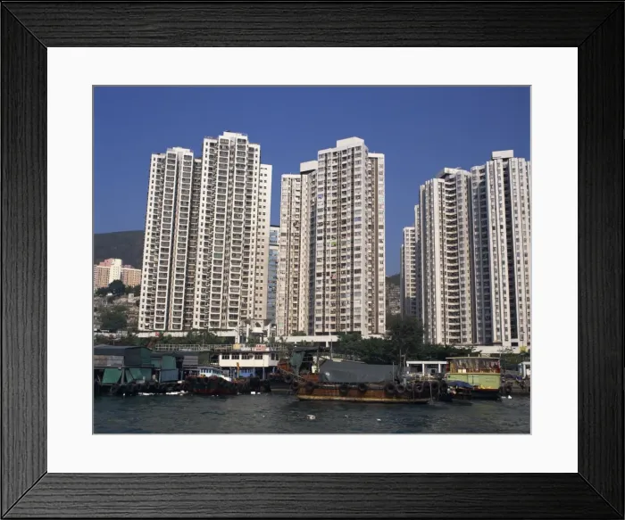 Framed Print : Boats in the harbour and new high rise apartment blocks for people who lived in sampans Framed Print : Boats in the harbour and new high rise apartment blocks for people who lived in sampans