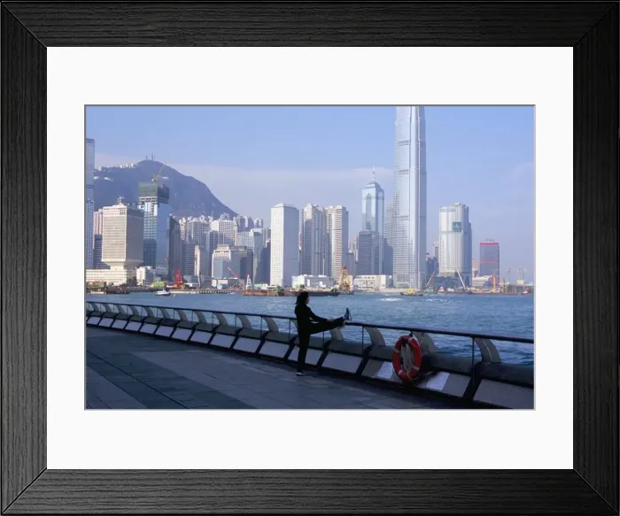 Framed Print : Morning exercise, Victoria Harbour and Hong Kong Island skyline, Hong Kong, China, Asia Framed Print : Morning exercise, Victoria Harbour and Hong Kong Island skyline, Hong Kong, China, Asia