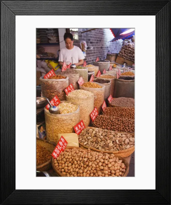 Framed Print : Vendor selling nuts at a market in the Muslim Quarter, home to the citys Hui community Framed Print : Vendor selling nuts at a market in the Muslim Quarter, home to the citys Hui community