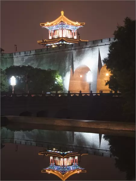 City wall and watch tower reflected in water, built during the first reign of Hongwu the first emperor of the Ming dynasty, Xian City, Shaanxi Province