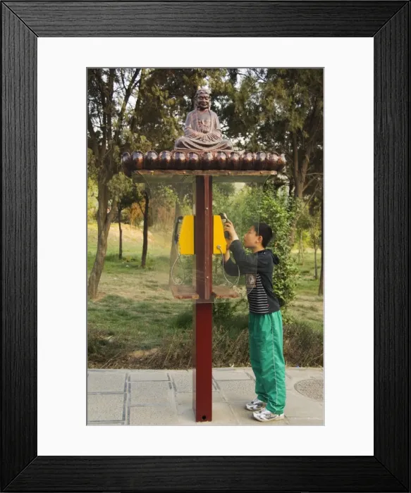 Framed Print : A boy using a monk decorated telephone box at Shaolin temple, birthplace of Kung Fu martial arts Framed Print : A boy using a monk decorated telephone box at Shaolin temple, birthplace of Kung Fu martial arts