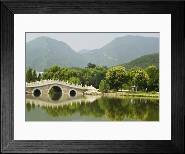 Framed Print : An arched stone bridge reflecting in a lake at Beijing Botanical Gardens Framed Print : An arched stone bridge reflecting in a lake at Beijing Botanical Gardens