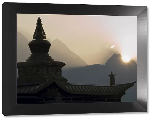 Buddhist temple at dawn with mountains beyond, Snow mountain, Tagong Grasslands