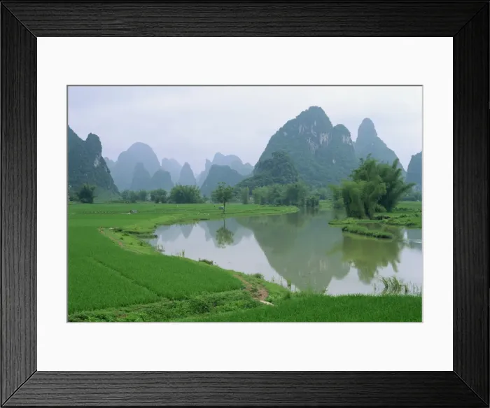 Framed Print : Reflections in water and the distinctive karst limestone landscape typical of the region south of Guilin, Guangxi, Yangshuo Framed Print : Reflections in water and the distinctive karst limestone landscape typical of the region south of Guilin, Guangxi, Yangshuo
