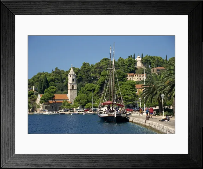 Framed Print : Sailing boat on the waterfront, with trees and church in the background at Cavtat Framed Print : Sailing boat on the waterfront, with trees and church in the background at Cavtat