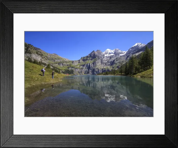 Framed Print : Hikers admire Lake Oeschinensee, Bernese Oberland, Kandersteg, Canton of Bern, Switzerland Framed Print : Hikers admire Lake Oeschinensee, Bernese Oberland, Kandersteg, Canton of Bern, Switzerland