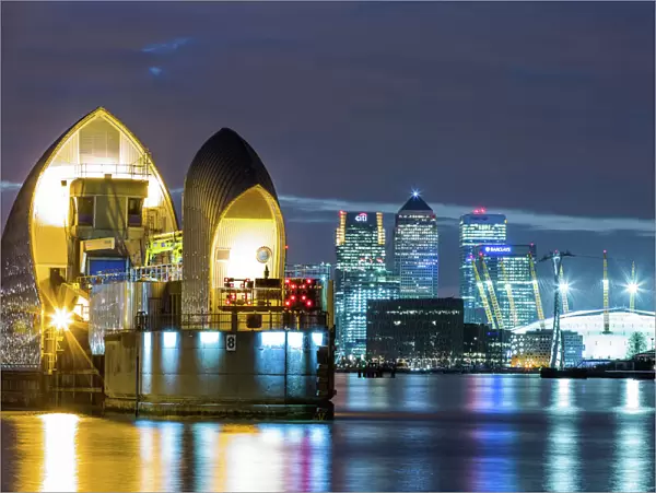 Thames Barrier, Millennium Dome (O2 Arena) and Canary Wharf at night, London, England