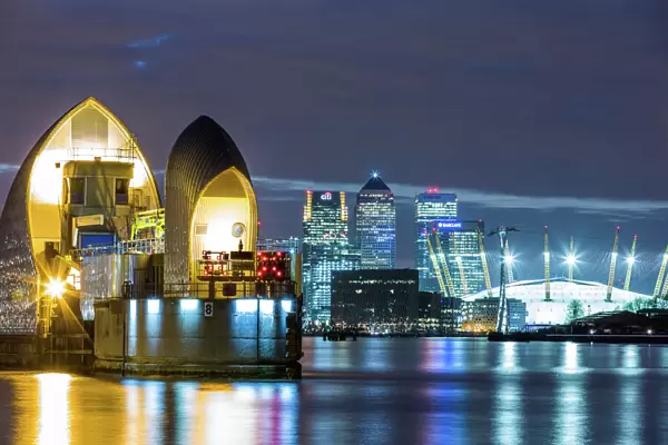 Thames Barrier, Millennium Dome (O2 Arena) and Canary Wharf at night, London, England