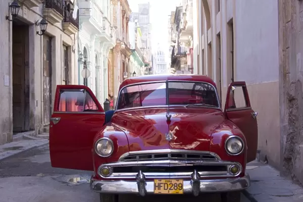 An old car in a small street in Habana Vieja (old town), Havana, Cuba, West Indies