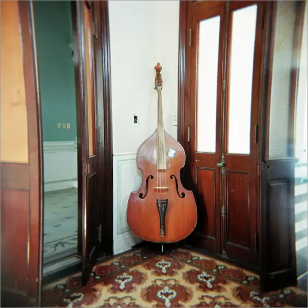 Double bass propped against a wall, Cienfuegos, Cuba, West Indies, Central America