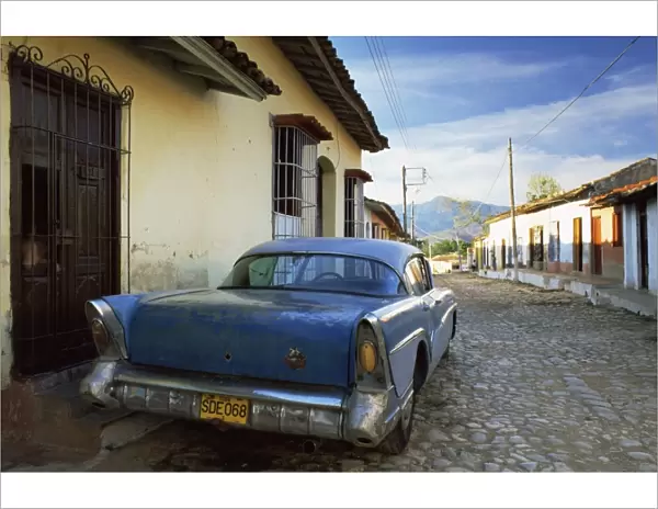 Old American car parked on cobbled street, Trinidad, Cuba, West Indies, Central America
