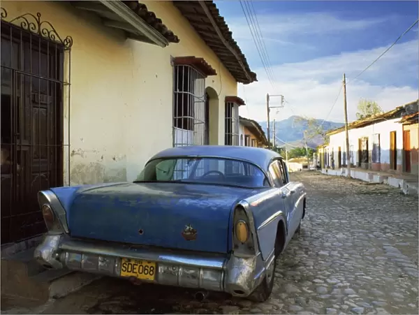 Old American car parked on cobbled street, Trinidad, Cuba, West Indies, Central America
