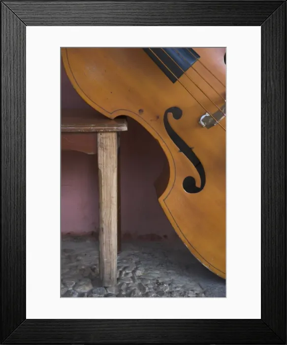 Framed Print : Close-up of a counterbass leaning against a wooden table, Trinidad, Sancti Spiritus province Framed Print : Close-up of a counterbass leaning against a wooden table, Trinidad, Sancti Spiritus province