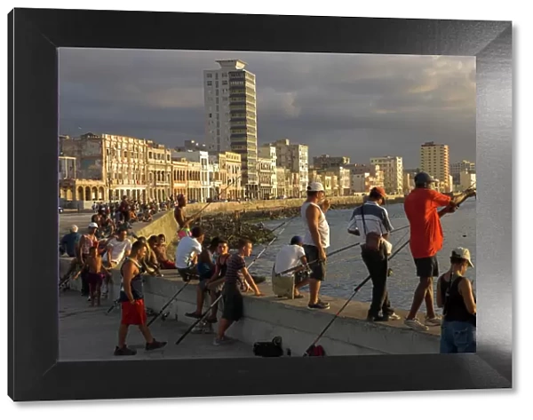 Men fishing at sunset, Avenue Maceo, El Malecon, Havana, Cuba, West Indies