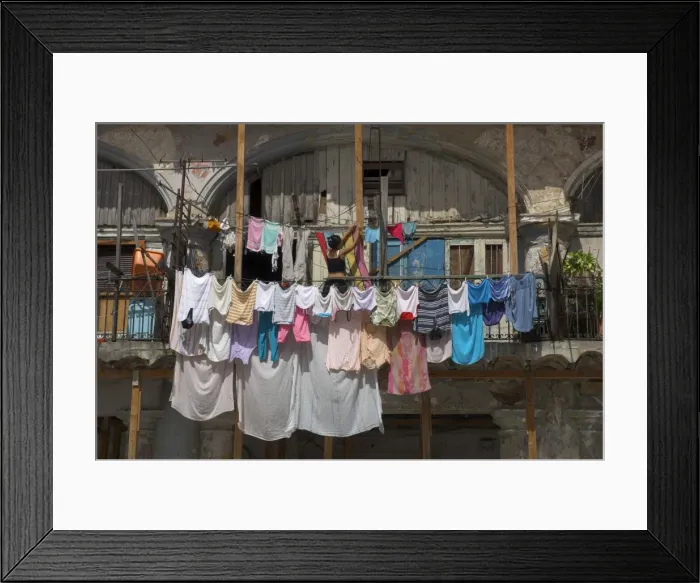 Framed Print : Large quantity of laundry hanging from the balcony of a crumbling building