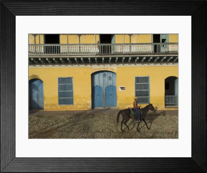 Framed Print : Man riding horse past the Galeria del Arte (Art Gallery), Plaza Mayor, Trinidad Framed Print : Man riding horse past the Galeria del Arte (Art Gallery), Plaza Mayor, Trinidad