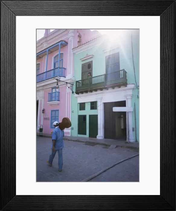 Framed Print : Man with guitar walking past coloured buildings in central Havana, Cuba Framed Print : Man with guitar walking past coloured buildings in central Havana, Cuba