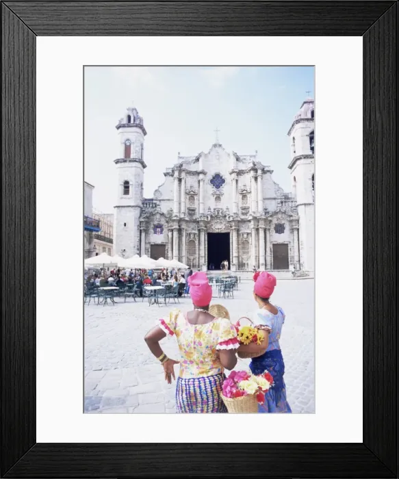Framed Print : Two women in traditional clothing looking at San Cristobal cathedral, Havana Framed Print : Two women in traditional clothing looking at San Cristobal cathedral, Havana